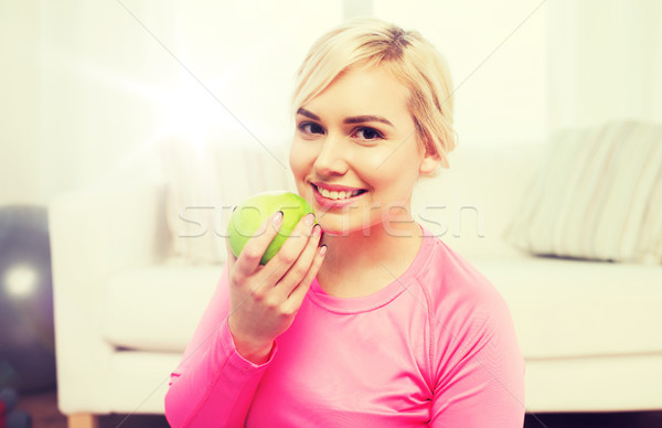 happy woman eating apple at home Stock photo © dolgachov