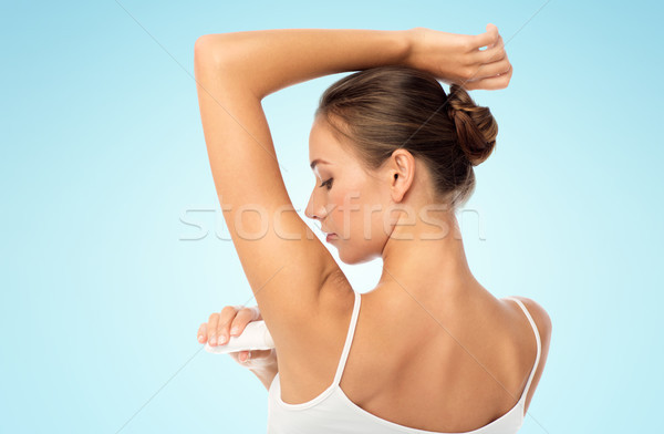woman with antiperspirant deodorant over white Stock photo © dolgachov