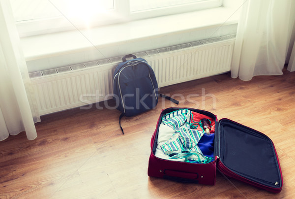 close up of travel bag with clothes and backpack Stock photo © dolgachov