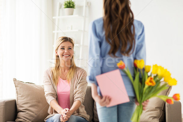 happy girl giving flowers to mother at home Stock photo © dolgachov