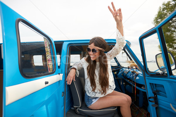 happy hippie woman showing peace in minivan car Stock photo © dolgachov