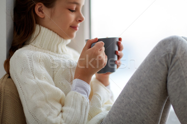 Kız çay kupa oturma ev pencere Stok fotoğraf © dolgachov