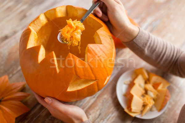 close up of woman carving halloween pumpkin Stock photo © dolgachov