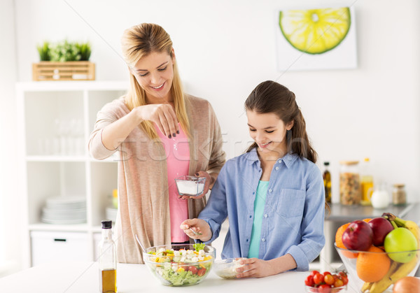 Stock photo: happy family cooking salad at home kitchen