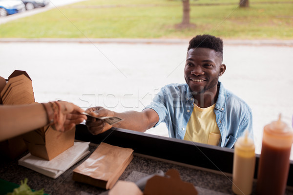 african american man buying wok at food truck Stock photo © dolgachov