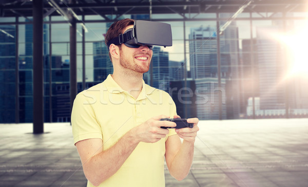 happy man in virtual reality headset with gamepad Stock photo © dolgachov