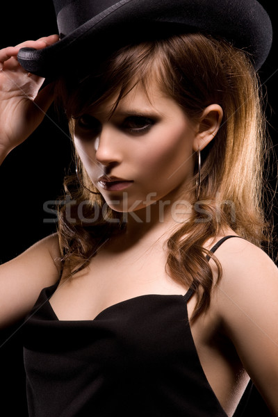 Vrouw zwarte jurk top hoed donkere foto Stockfoto © dolgachov