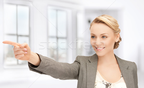 businesswoman pointing her finger Stock photo © dolgachov