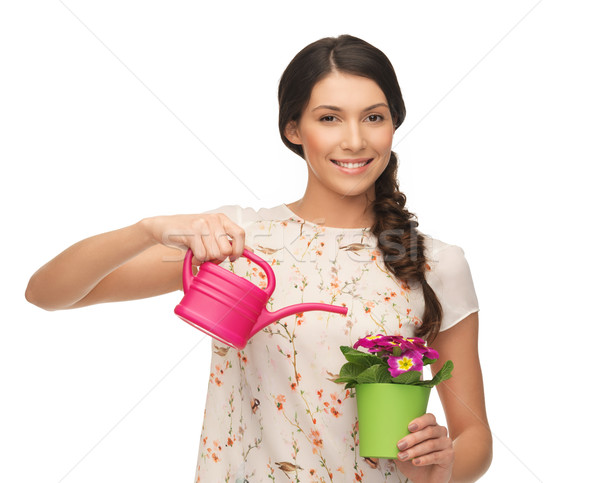 housewife with flower in pot and watering can Stock photo © dolgachov