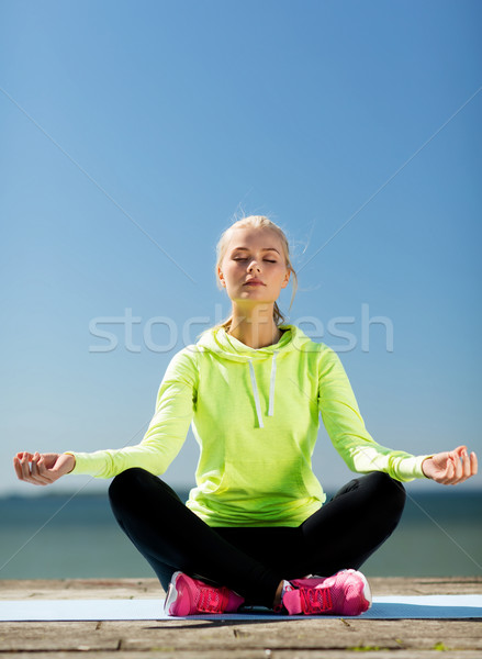 woman doing yoga outdoors Stock photo © dolgachov