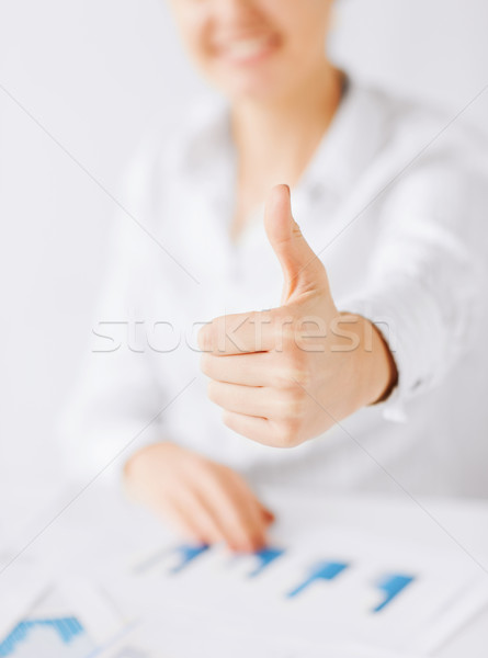 woman with charts, papers and thumbs up Stock photo © dolgachov