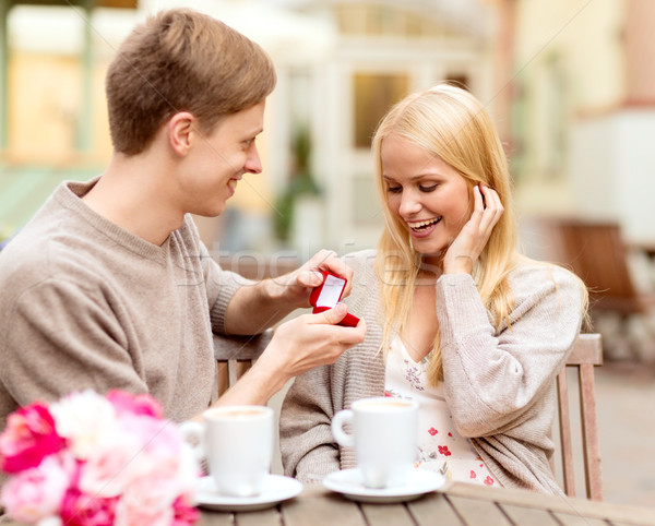 romantic man proposing to beautiful woman Stock photo © dolgachov