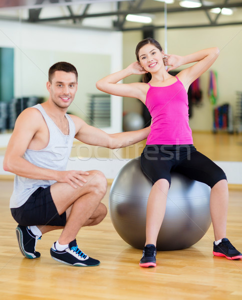 male trainer with woman doing crunches on the ball Stock photo © dolgachov