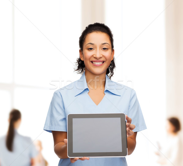 Stock photo: smiling female doctor or nurse with tablet pc