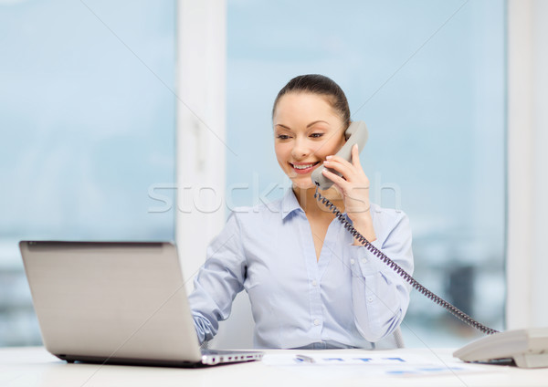 businesswoman with phone, laptop and files Stock photo © dolgachov