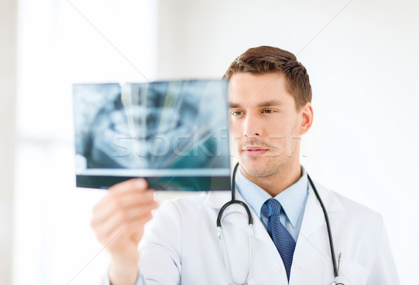 concerned male doctor or dentist looking at x-ray Stock photo © dolgachov