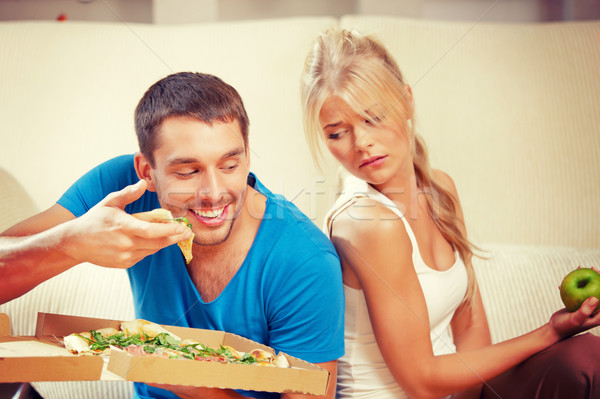 couple eating different food Stock photo © dolgachov
