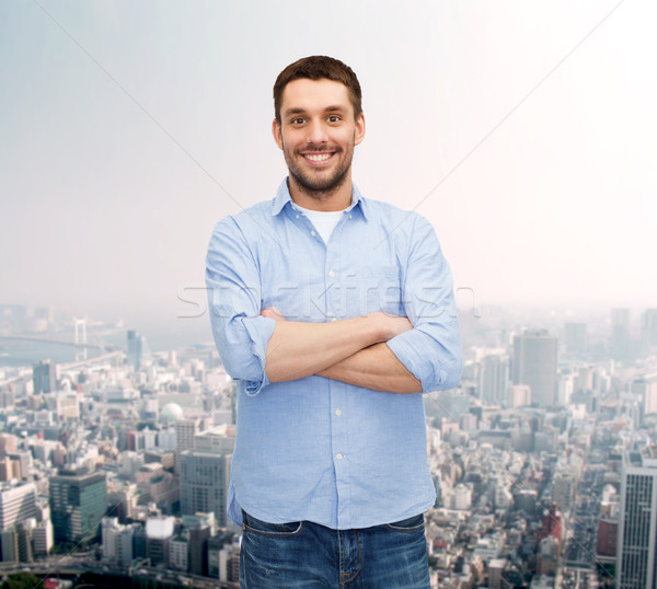 smiling man with crossed arms Stock photo © dolgachov