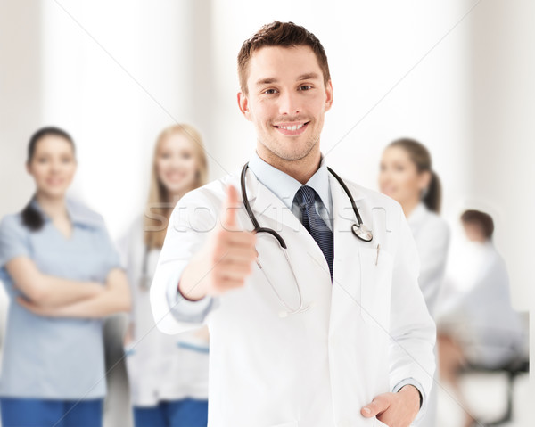 doctor with stethoscope showing thumbs up Stock photo © dolgachov