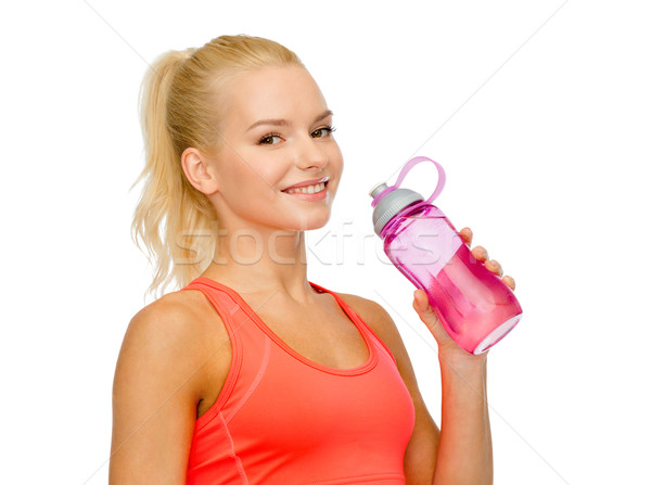 smiling sporty woman with water bottle Stock photo © dolgachov