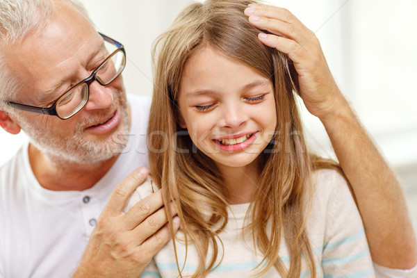 grandfather with crying granddaughter at home Stock photo © dolgachov