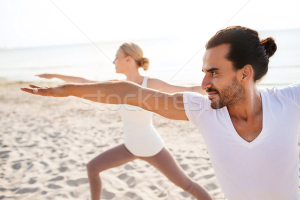 close up of couple making yoga exercises outdoors Stock photo © dolgachov