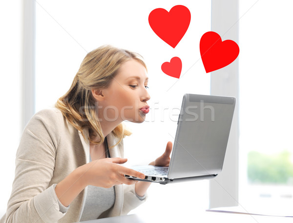 woman sending kisses with laptop computer Stock photo © dolgachov