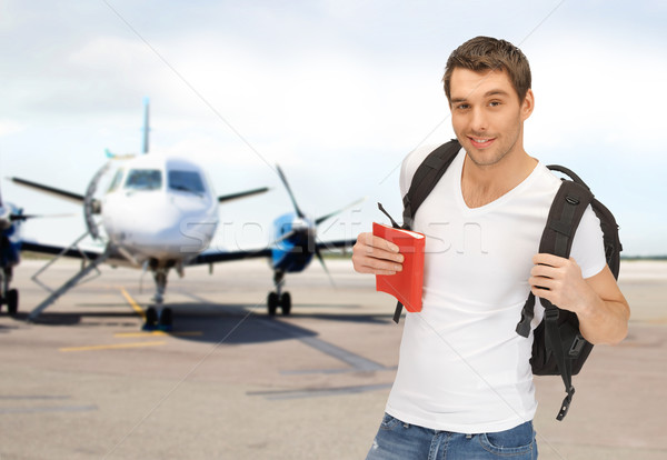 smiling student with backpack and book at airport Stock photo © dolgachov