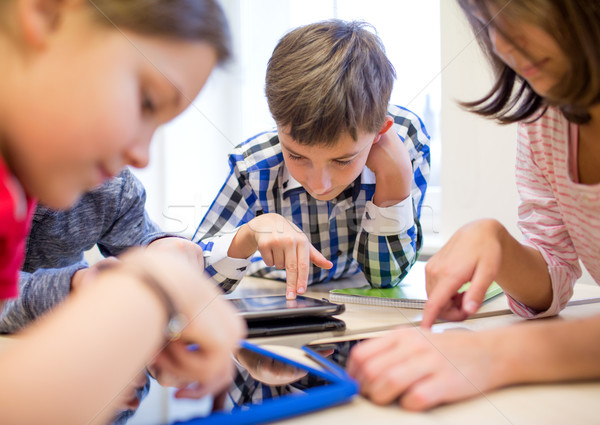 Stock photo: group of school kids with tablet pc in classroom
