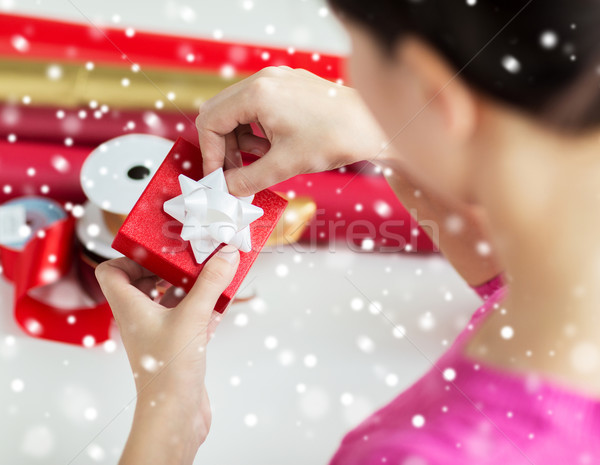 close up of woman decorating christmas present Stock photo © dolgachov