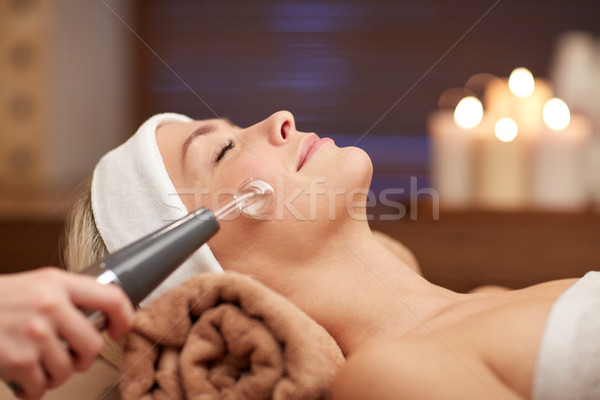 close up of young woman having face massage in spa Stock photo © dolgachov