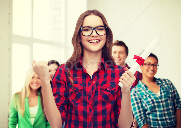 smiling female student in eyeglasses with diploma Stock photo © dolgachov