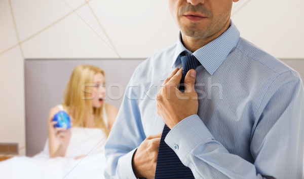 close up of man adjusting tie on neck in bedroom Stock photo © dolgachov