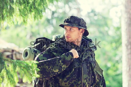 soldier or hunter shooting with gun in forest Stock photo © dolgachov