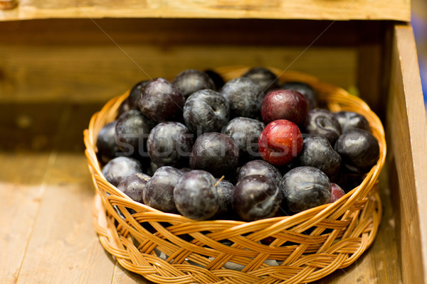 Stock photo: ripe plums in basket at farm or food market