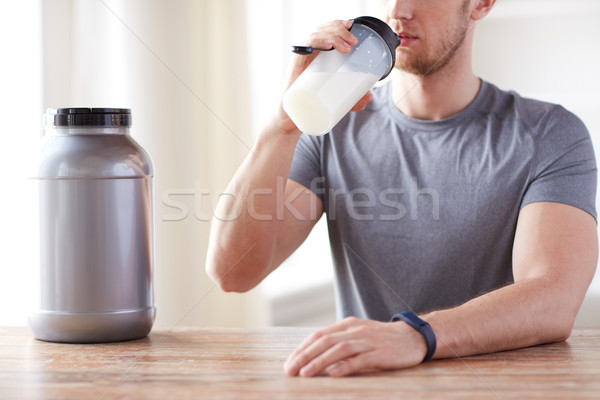 close up of man drinking protein shake Stock photo © dolgachov