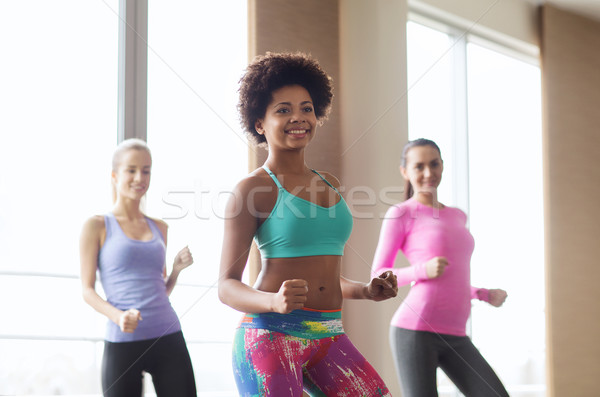 group of smiling people dancing in gym or studio Stock photo © dolgachov