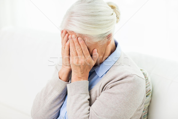 Starszy kobieta cierpienie głowy żal Zdjęcia stock © dolgachov
