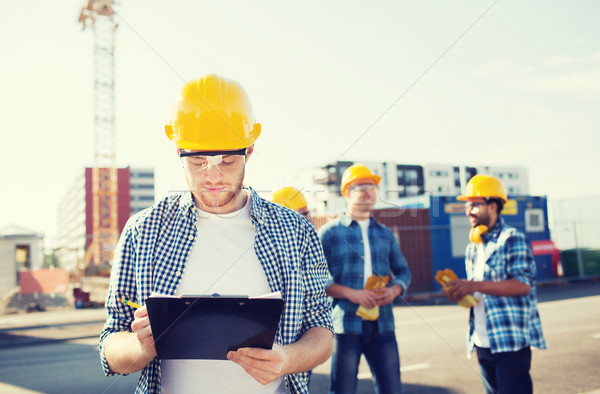 Stock photo: group of builders in hardhats outdoors