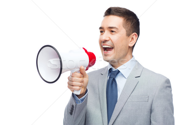 happy businessman in suit speaking to megaphone Stock photo © dolgachov