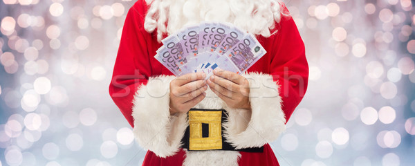 Stock photo: close up of santa claus with euro money