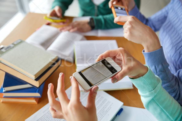students with smartphones making cheat sheets Stock photo © dolgachov