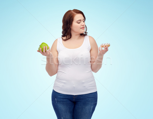 young plus size woman choosing apple or cookie Stock photo © dolgachov