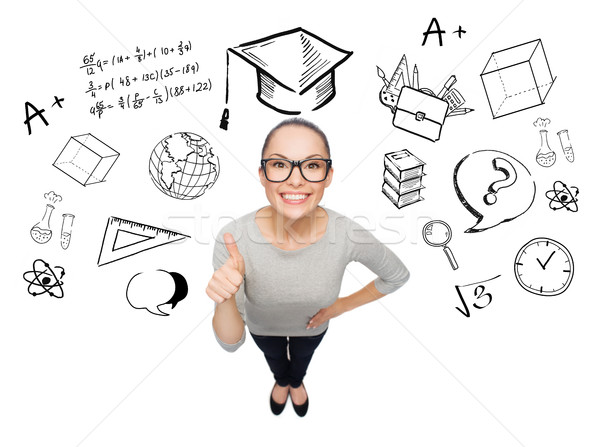 happy woman showing thumbs up over school doodles Stock photo © dolgachov