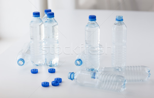 close up of bottles with drinking water on table Stock photo © dolgachov