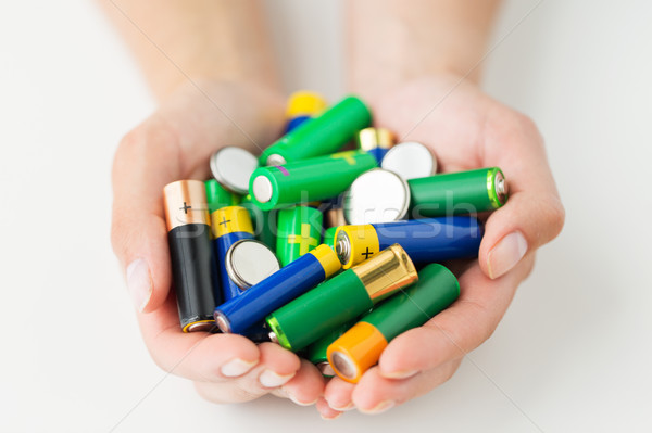 close up of hands holding alkaline batteries heap Stock photo © dolgachov