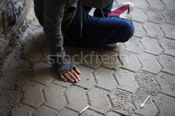 Stock photo: close up of addict woman and drug syringes
