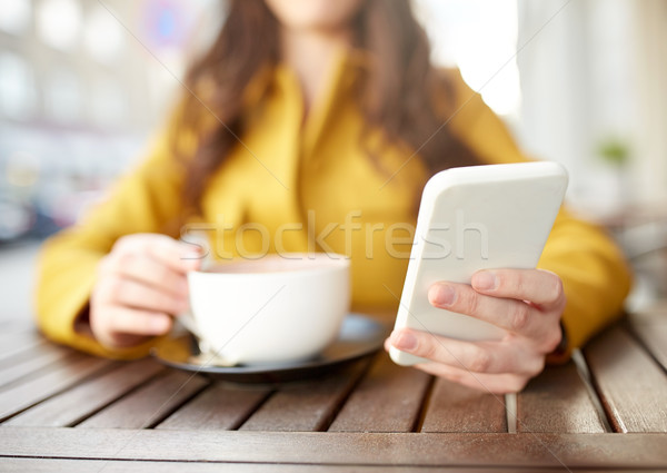Stock photo: close up of woman texting on smartphone at cafe