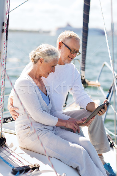 senior couple with tablet pc on sail boat or yacht Stock photo © dolgachov
