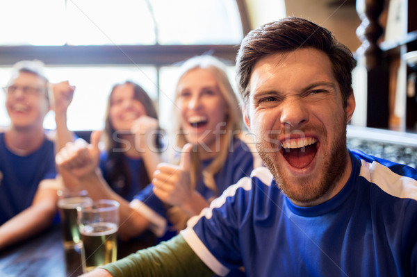 Stock photo: football fans or friends with beer at sport bar